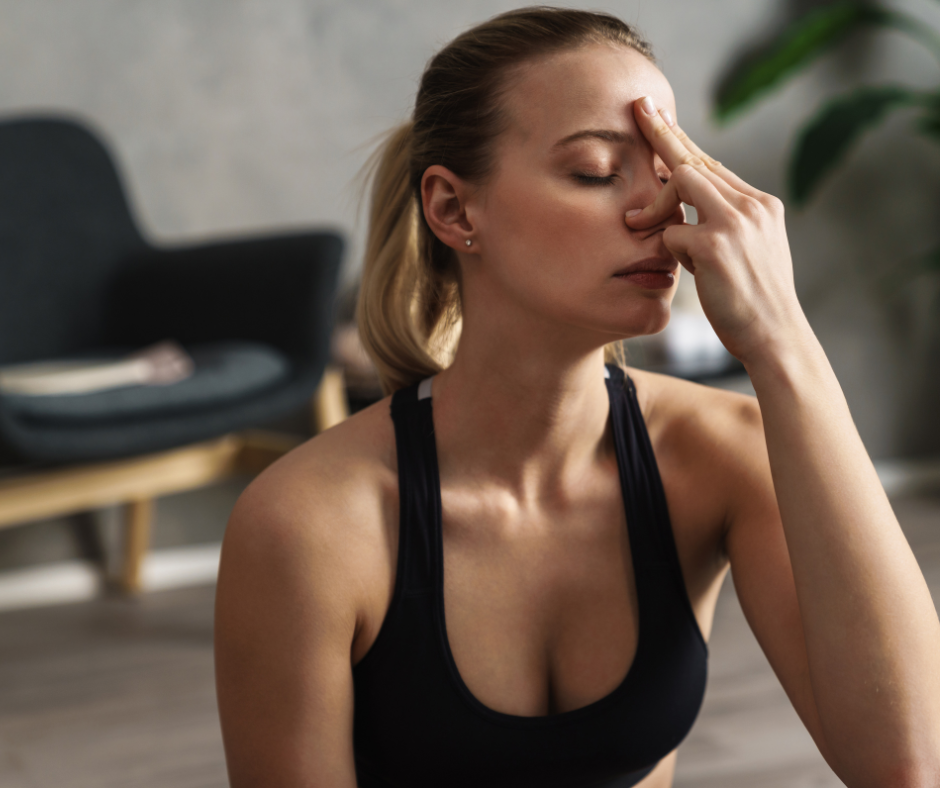 Woman practicing alternate nostril breathing - an anxiety breathing technique.