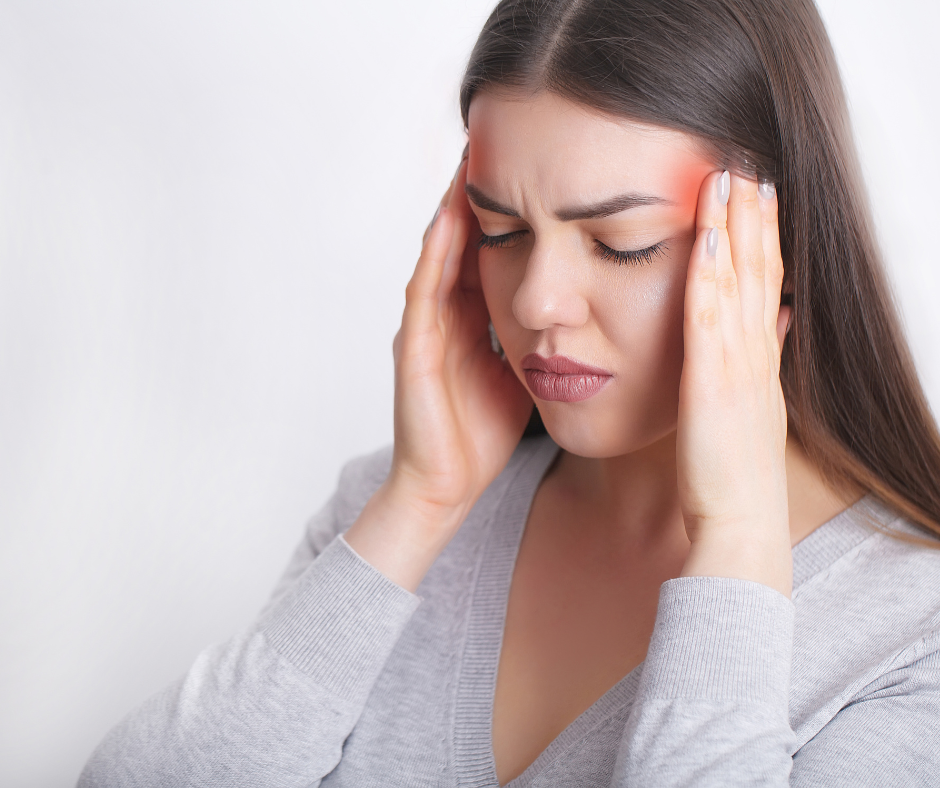 Anxiety physical symptoms - woman suffering from headache.