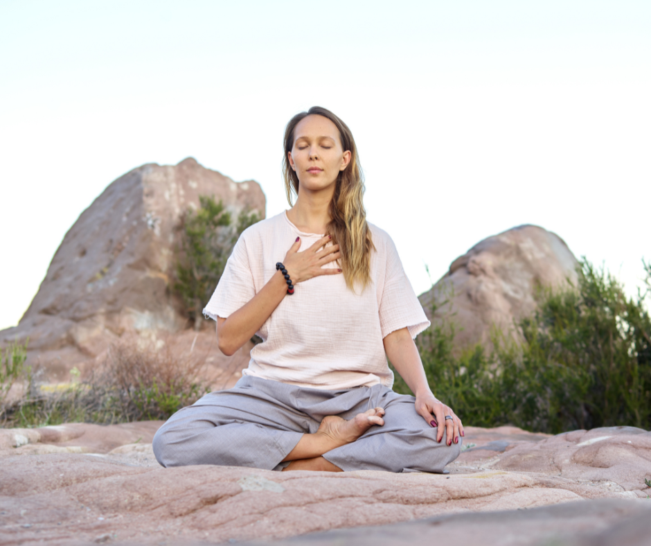 Anxiety meditation: woman meditating outdoors.