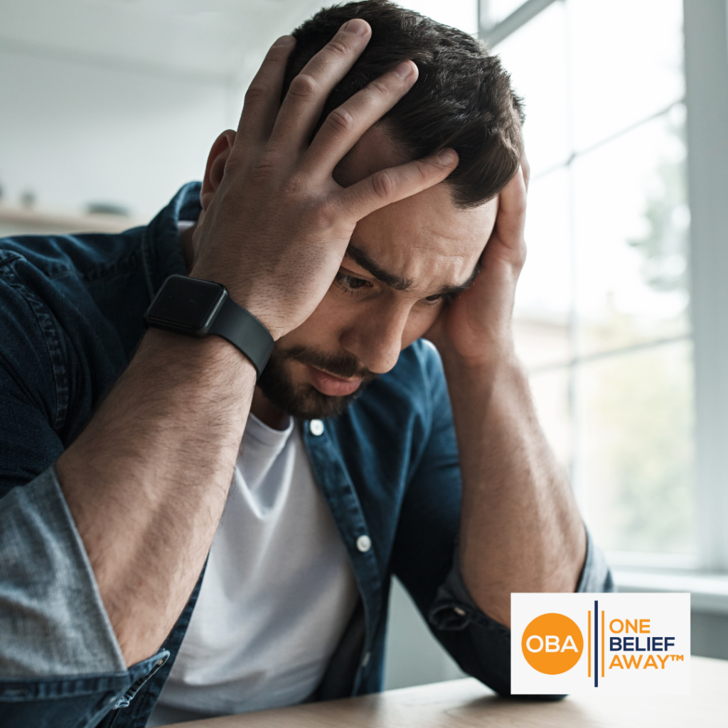 Man sitting with his head in his hands experiencing fear and dread.