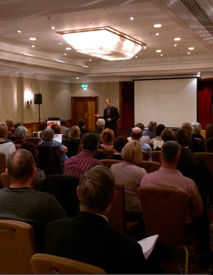 Tim Shurr presenting to a seated professional audience